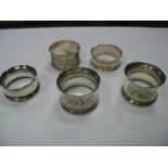 A Pair of Hallmarked Silver Napkin Rings, reeded and leaf scroll engraved; together with three