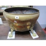 An Early XX Century Brass Log Basket, with lion handles, on paw feet.