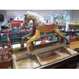 A Mid XX Century Pine Based Rocking Horse, with hair to mane. Approximately 79cm high.