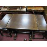 An Oak Draw Leaf Table, rectangular, with cup and cover supports united by a central stretcher.