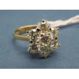 An 18ct Gold Seven Stone Diamond Cluster Ring, of flowerhead design, claw set with brilliant cut