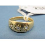 An 18ct Gold Three Stone Ring, graduated star set to the front.