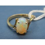 A Single Stone Opal Ring, the central oval cabochon four claw set, between crossover shoulders