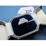 An Art Deco Diamond Set Ring, the high square panel set with graduated old and single cut stones,