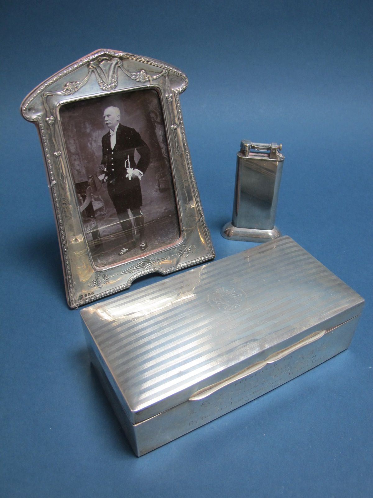 A Hallmarked Silver Cigarette Box, (marks rubbed) of rectangular form, the hinged lid engine