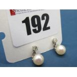 A Pair of 18ct White Gold Diamond and Pearl Set Earrings, each claw set single stone surmount,