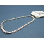 A Modern 18ct White Gold Diamond Set Tennis Bracelet, of uniform design, claw set throughout with