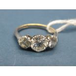 A Three Stone Diamond Ring, claw set with three graduated old cut stones, stamped "18ct".