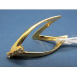 A Wishbone Ring, of elongated design with claw set highlights, stamped "18ct".