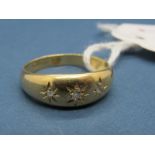 An 18ct Gold Three Stone Ring, graduated star set.