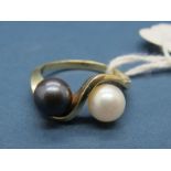 A Modern Pearl Set Dress Ring, set with black and white pearls, of crossover twist design,