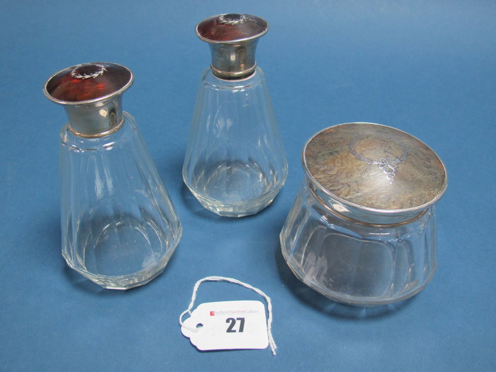 A Pair of Hallmarked Silver and Piqué Work Topped Glass Bottles, Adie Bros, Birmingham 1927, each of