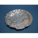 A Decorative Dish, of stylised fruit design, allover detailed in relief, raised on three scroll