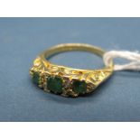 An 18ct Gold Emerald and Diamond Set Ring, of graduated design with claw set highlights, within