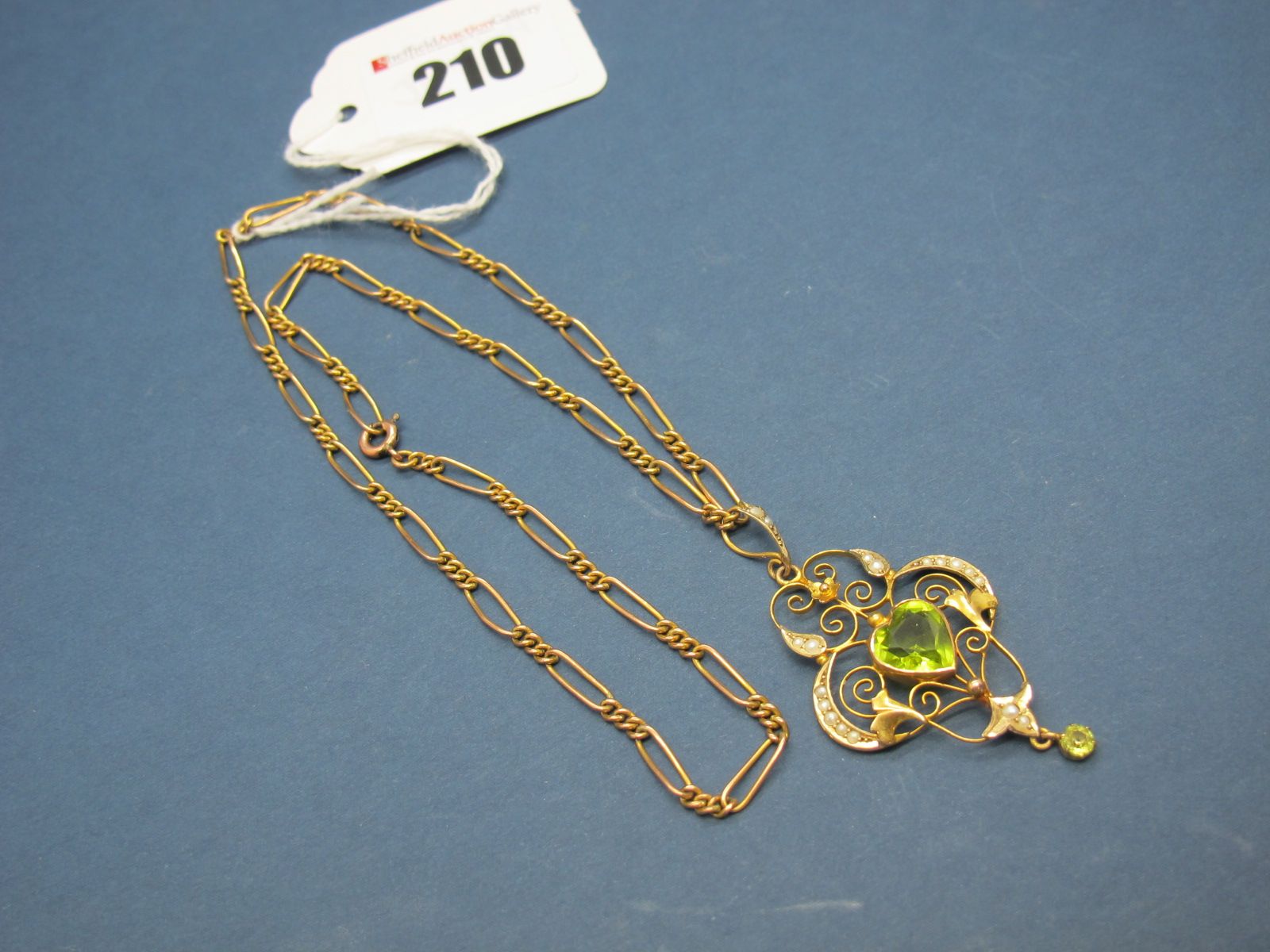 An Edwardian Openwork Pendant, heart shape collet set to the centre, with pearl highlights,