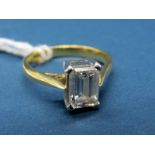 An 18ct Gold Emerald Cut Single Stone Diamond Ring, the 7x5mm stone four claw set between plain