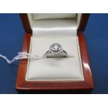 A Modern 18ct White Gold Single Stone Diamond Ring, the brilliant cut stone halo set within border