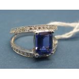 A Modern 18ct White Gold Tanzanite and Diamond Set Dress Ring, the central emerald cut tanzanite