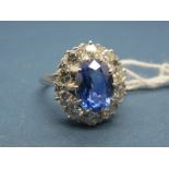 A Large Sapphire and Diamond Cluster Ring, the central (9mm) oval sapphire claw set, within claw set