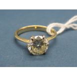 A Single Stone Diamond Ring, the (8mm) brilliant cut stone claw set, stamped "750".