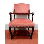 An Early XX Century Mahogany Armchair, with arched top rail, upholstered back and seat, scroll