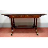 An Early XIX Century Mahogany Sofa Table, with drop leaves, two single and two dummy drawers, on
