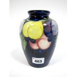 A Moorcroft Pottery Vase, of ovoid form, painted in the 'Wisteria' pattern against a dark blue