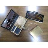 A Volupté (USA) Gilt Metal Compact Carry-All, with lipstick, powder and cigarette compartments and