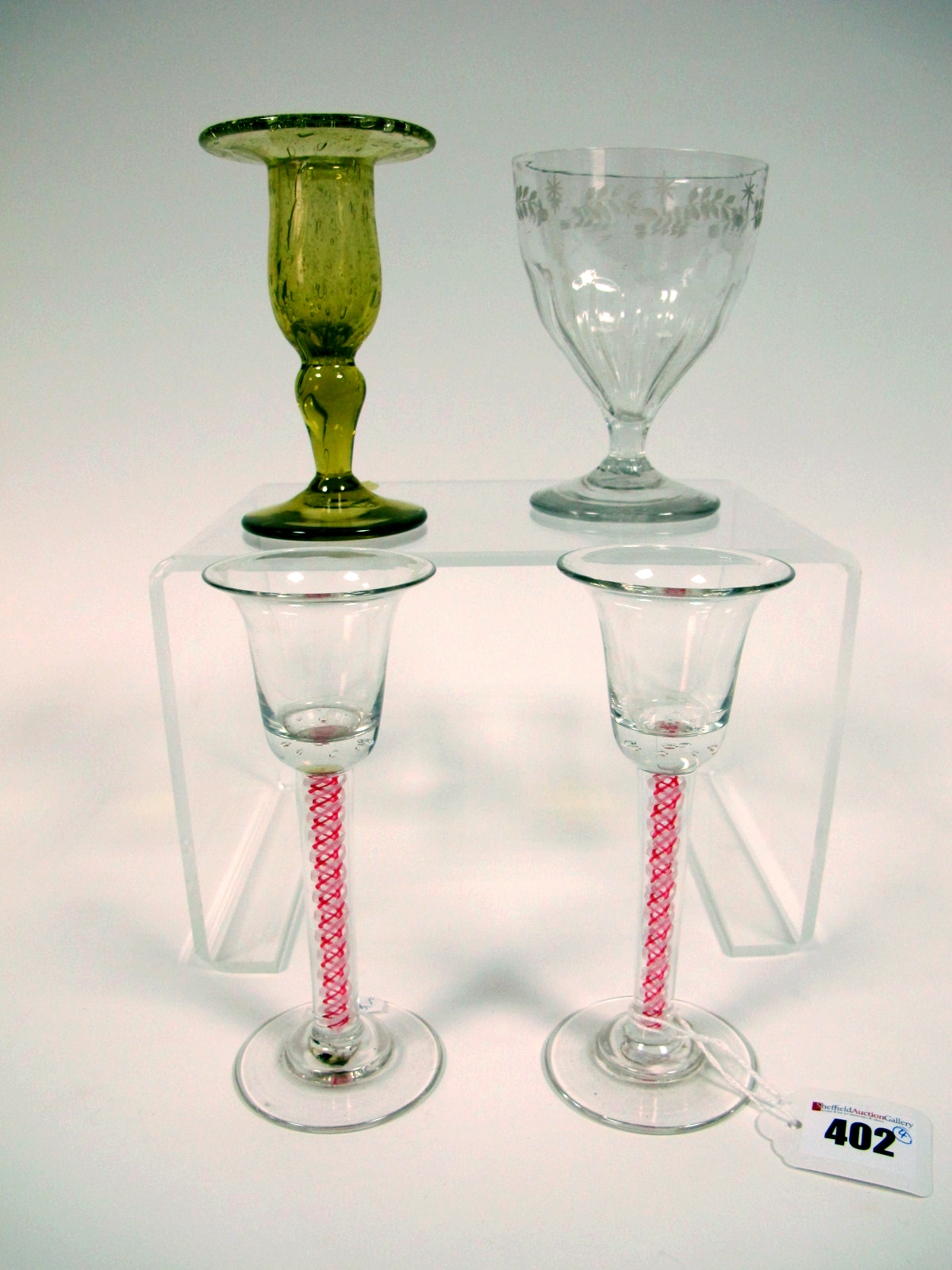 A Pair of XIX Century Wine Glasses, the bell shaped bowls raised on red and white enamel twist stems