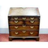 A Mid- Late XVIII Century Mahogany Bureau, with fall front, stepped interior, and long drawer over