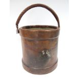 A XIX Century Leather Fire Bucket, of barrel form, with swing handle and canvas interior,