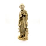 A Late XIX Century Japanese Ivory Figure, carved as a scholar holding a scroll and standing beside a