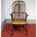 A XIX Century Yew Wood Windsor Chair, with hooped back and pierced splat, the elm seat stamped "
