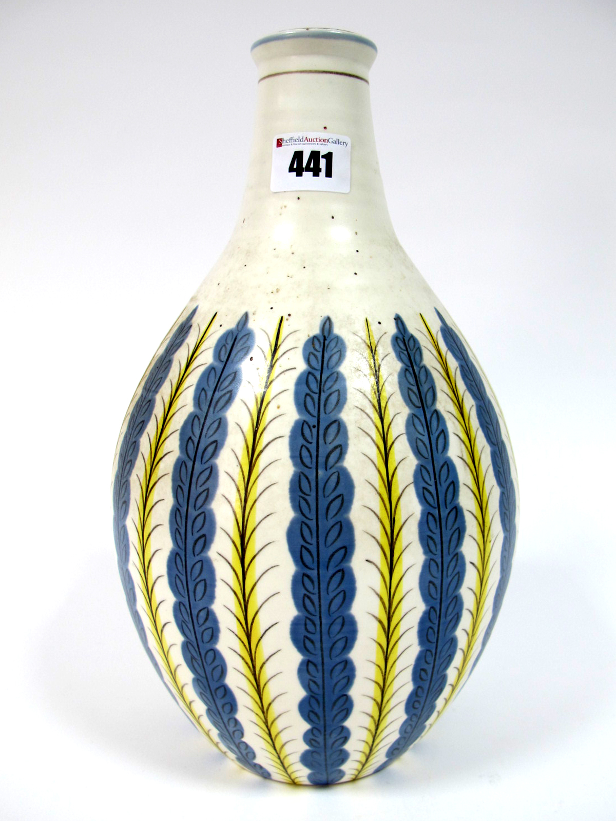 An Early 1950's Poole Pottery White Earthenware Carafe Vase, the blue and yellow stylised leaf