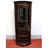An Early XX Century Mahogany Corner Cupboard, with a stepped cornice, glazed astragal door, four