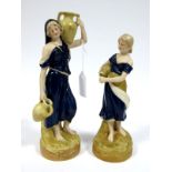 A Pair of Royal Dux Porcelain Figures, modelled as female water carriers, each carrying large urns