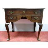An XVIII Century Oak Lowboy, the top with moulded edge and one long and two short drawers, on