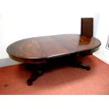 A XIX Century Mahogany Dining Table, the oval top with moulded edge, half round pedestal supports,