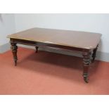 A Mid XIX Century Mahogany Wind-Out Dining Table, the top with moulded edge, raised on turned and