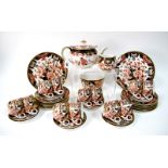 A Late XIX Century Derby Porcelain Tea Service, decorated in Imari pattern 383, with flowering trees