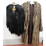 A c.1920's Black Bear Skin Jacket, collarless with gilt metal clasp featuring a Roman centurion in a