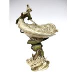 An Art Nouveau Royal Dux Porcelain Centrepiece, modelled as a lady leaning against a shell shaped