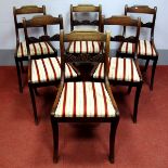 A Set of Six Regency Mahogany Dining Chairs, with shaped top rail, carved centre rail and drop-in