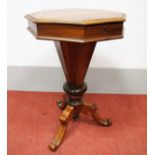 A XIX Century Walnut Sewing Table, with octagonal hinged top with moulded edge, fitted interior,