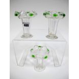 A Set of Three Art Nouveau Glass Vases, of fluted tapered form with outcurved wavy rim with green