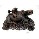 A Late XIX Century Chinese Hardwood Carved Model of Two Boys Upon a Recumbent Buffalo, upon a