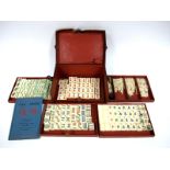 An Early XX Century Chinese Mah Jong Set, contained in a leather bound case, the fall front