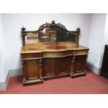 A Mid XIX Century Mahogany Serpentine Shaped Mirror Back Sideboard, the mirror with applied scroll