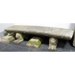 A Concrete Garden Bench, having stepped lunar seat on twin lion supports and stepped pedestals,