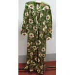 A 1950's Ladies Housecoat, wrap-over style in green satin with mauve and cream flowers, bow